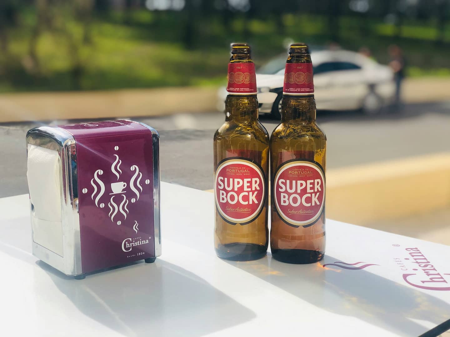 two brown glass bottles on white table