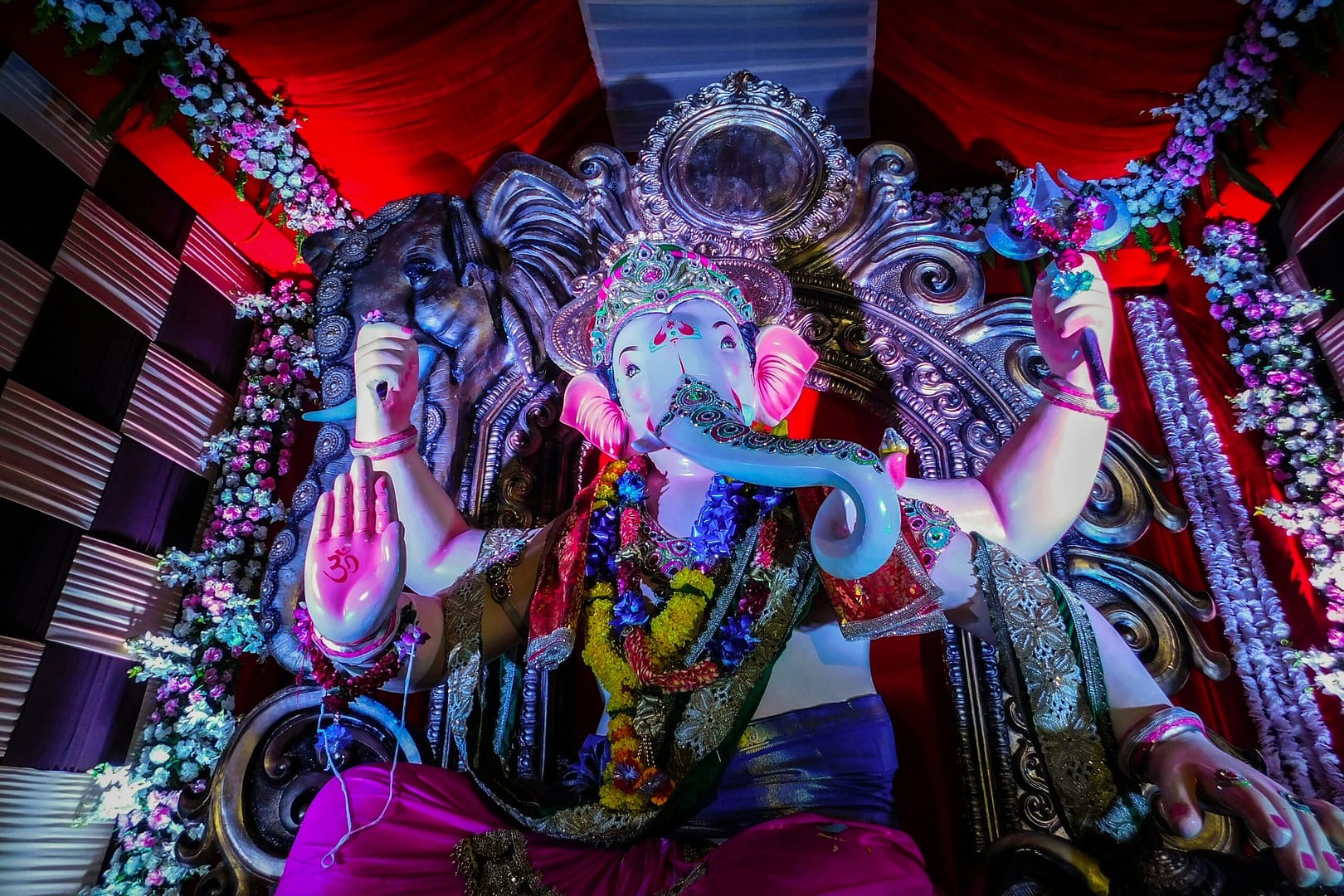 hindu deity statue on red textile