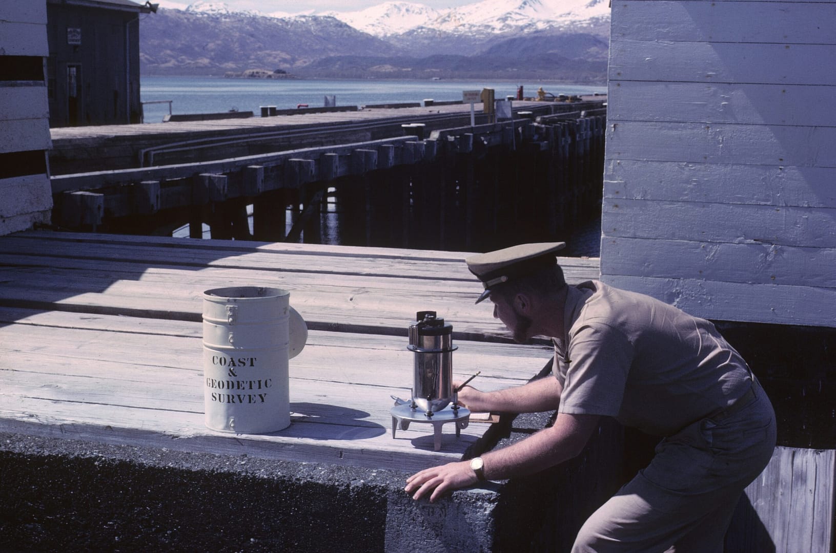 man in brown shirt and black pants sitting on gray concrete bench during daytime