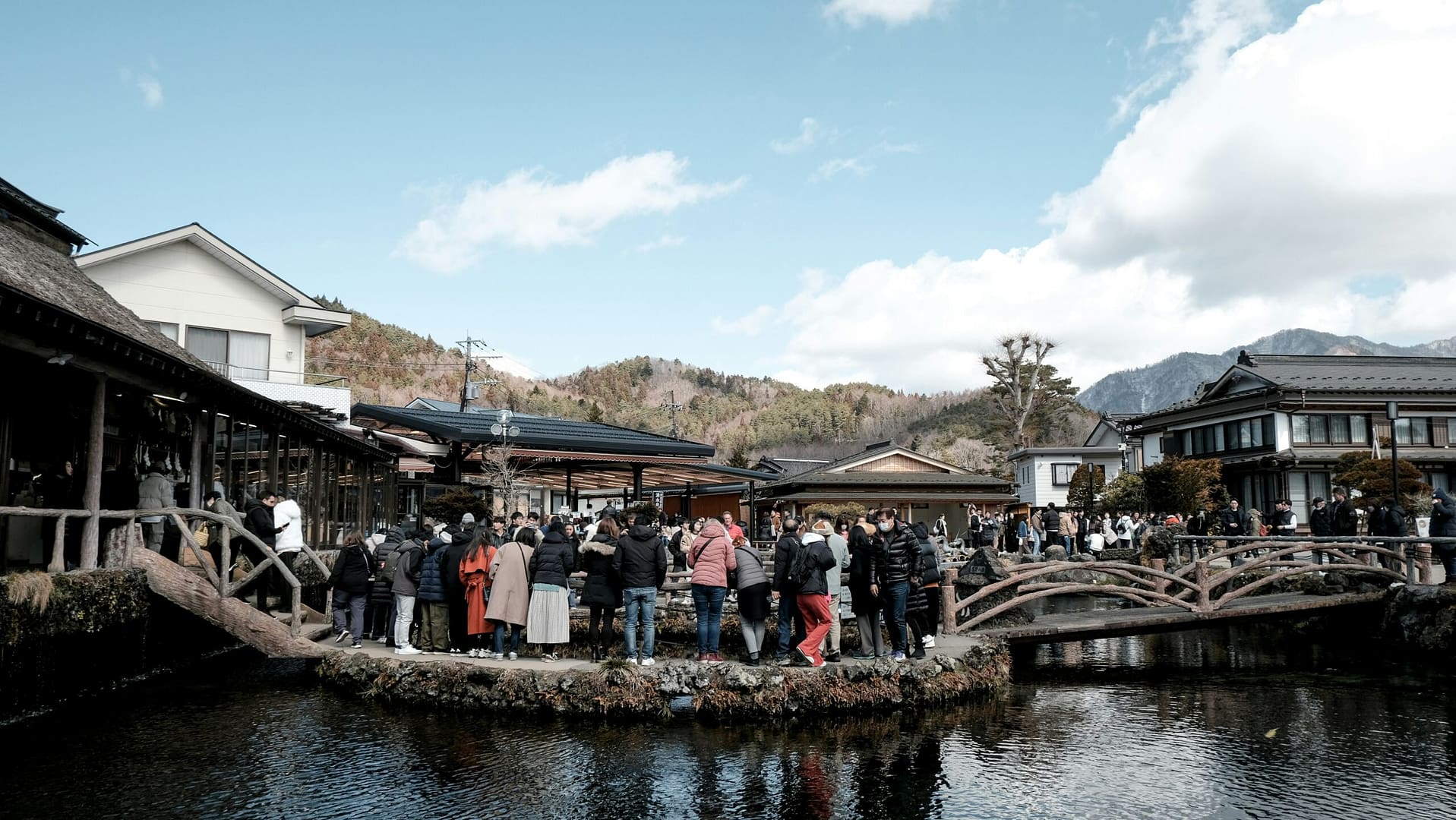 A group of people standing on a boat in a body of water